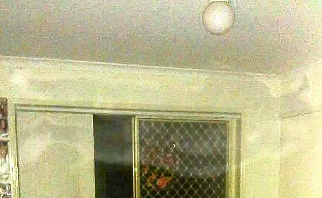 An eerie figure appears to be floating near the ceiling in this photo which was taken with a phone-camera. An eerie figure appears to be floating near the ceiling in this photo which was taken with a phone-camera.
